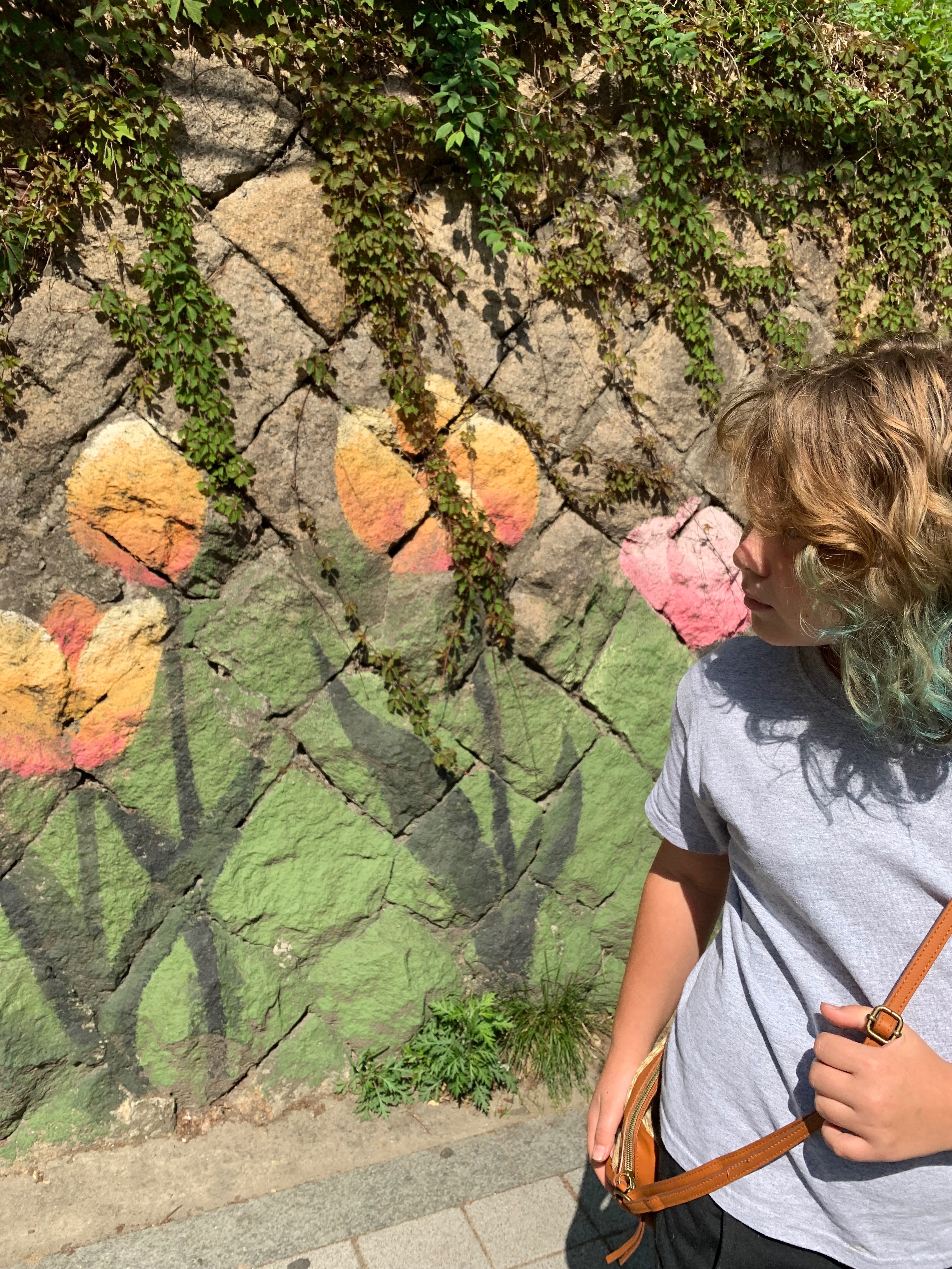 Street art with colorful flowers on stone wall